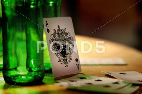 Ace of Spades Playing Card Leaning Against Beer Bottle Stock Photos