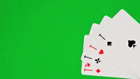 Aces on the green background of the game table. Stock Photos