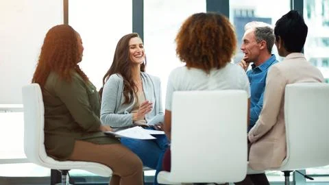Achieving organizational objects as a team. a team of colleagues having a Stock Photos