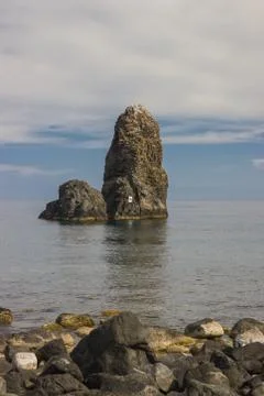 Aci Trezza Sicily vertical view of cyclopean rocks, beautiful coast and sky 스톡 사진