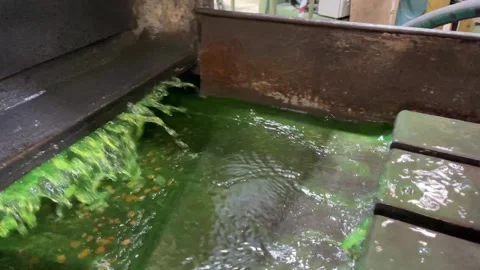Acid green coolant moving back and forth in a grinding machine, slow motion Stock Footage 219429847