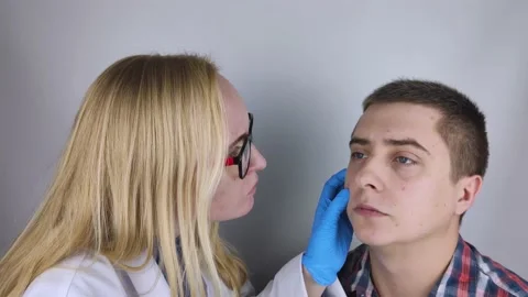 Acne and black dots close-up. A man is being examined by a doctor. Dermatologist Stock Footage 142731839