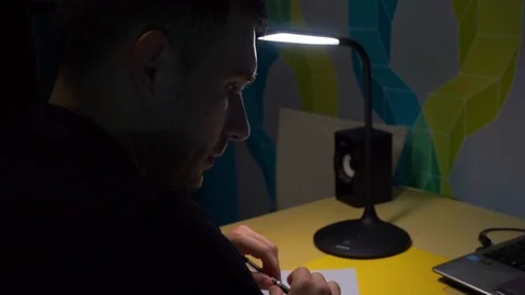 Acne guy with pen his hands, looks one point. Sits over sheet and thinks write. Stock Footage 121644482