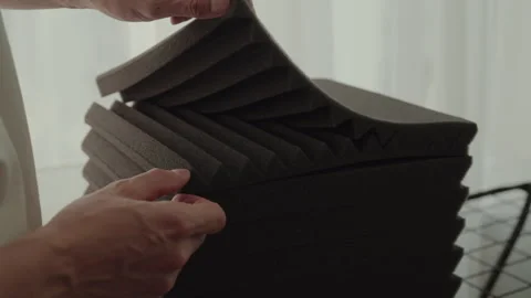 Acoustic engineer carefully splitting up layers of sound-absorbing foam. Concept Video stock 304882893