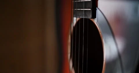 Acoustic guitar close up of the strings man's hands strumming the strings Stock Footage 207927182