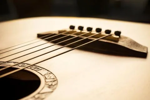Acoustic guitar focus on bridge and strings Stock Photos