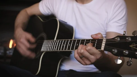 Acoustic Guitar Player in front of Fireplace 2 Stock Footage 88787215