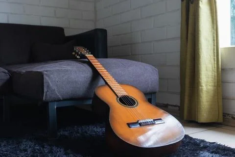 An acoustic guitar on the sofa Stock Photos
