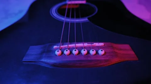 Acoustic Guitar Strings and Bridge in Moody Blue and Pink Light Stock Footage 325782562