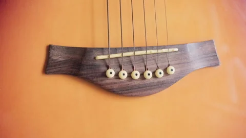 Acoustic guitar strings and bridge closeup view 库存影片 335022620