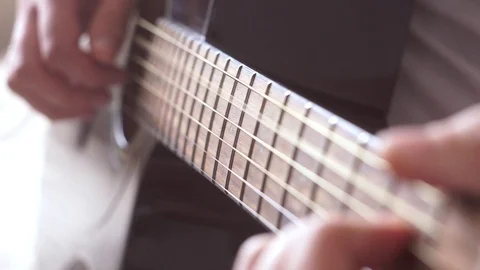 Acoustic guitar strings vibrate while playing. Guitar fretboard and male hand. Stock Footage 116625018