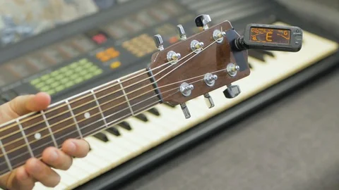 Acoustic guitar tuning Stock Footage 103807643