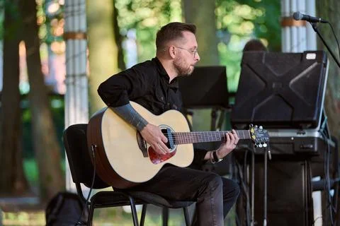 Acoustic performance in sunlit park setting Stock Photos