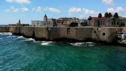 Acre (Akko) Boy Jumps off wall into water Drone Stock Footage 169055322