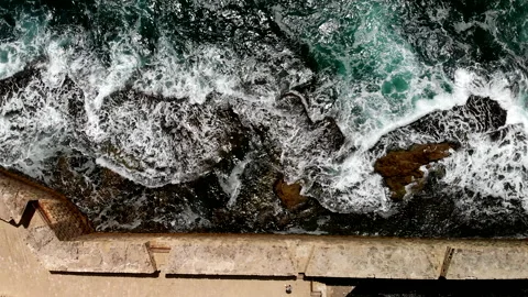 Acre (Akko) Waves breaking into rocks and wall Drone Stock Footage 169059077
