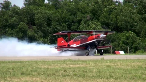 Acrobaster PS-2B with number NI29PS produces demonstration white smoke on runway Stock Footage 121203777