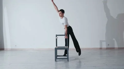 The acrobat keeps balance on the chairs. Acrobatic number without insurance Video stock 151646339
