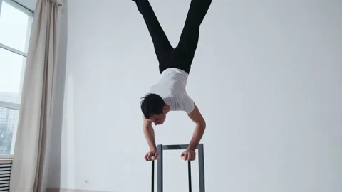 The acrobat keeps balance on the chairs. Acrobatic number without insurance Video stock 151646412