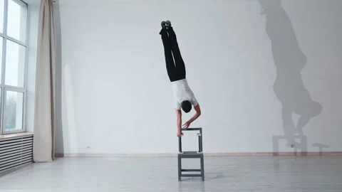 The acrobat keeps balance on the chairs. Acrobatic number without insurance Video stock 151646452