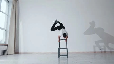 The acrobat keeps balance on the chairs. Acrobatic number without insurance Video stock 151646525