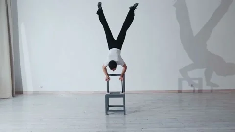 The acrobat keeps balance on the chairs. Acrobatic number without insurance Video stock 151646536