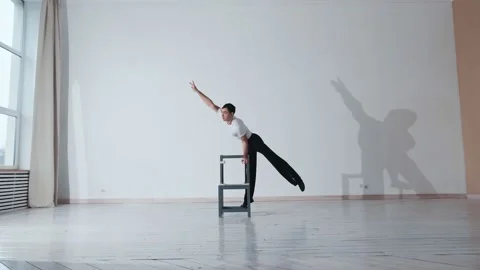 The acrobat keeps balance on the chairs. Acrobatic number without insurance Video stock 151646600