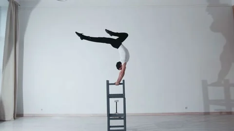The acrobat keeps balance on the chairs. Acrobatic number without insurance Video stock 151646692