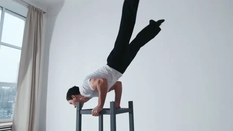 The acrobat keeps balance on the chairs. Acrobatic number without insurance Video stock 151646752