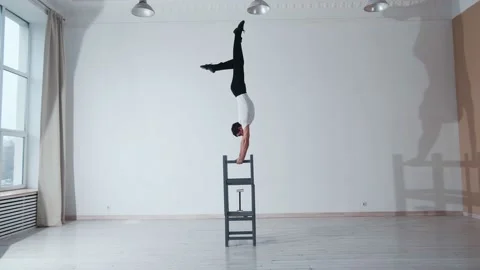 The acrobat keeps balance on the chairs. Acrobatic number without insurance Video stock 151646798
