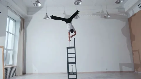The acrobat keeps balance on the chairs. Acrobatic number without insurance Video stock 151646865