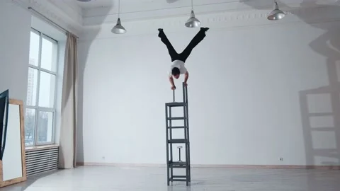The acrobat keeps balance on the chairs. Acrobatic number without insurance Video stock 151646875