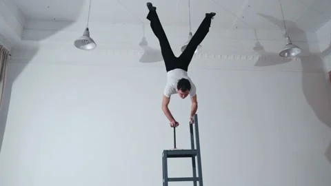 The acrobat keeps balance on the chairs. Acrobatic number without insurance Video stock 151646967