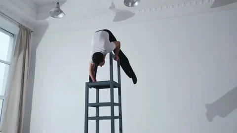 The acrobat keeps balance on the chairs. Acrobatic number without insurance Video stock 151647051