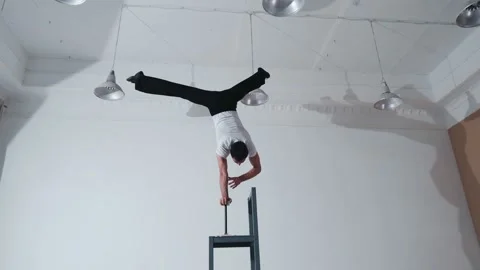 The acrobat keeps balance on the chairs. Acrobatic number without insurance Video stock 151647057