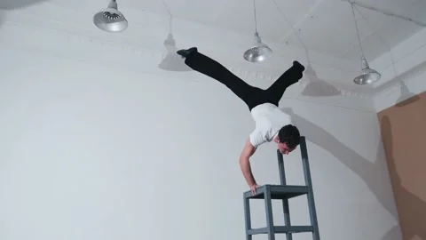 The acrobat keeps balance on the chairs. Acrobatic number without insurance Video stock 151647233
