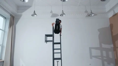 The acrobat keeps balance on the chairs. Acrobatic number without insurance Video stock 151647355