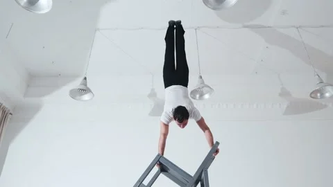 The acrobat keeps balance on the chairs. Acrobatic number without insurance Video stock 151647563
