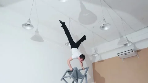 The acrobat keeps balance on the chairs. Acrobatic number without insurance Video stock 151647683