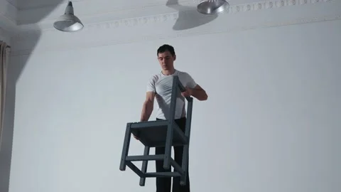 The acrobat keeps balance on the chairs. Acrobatic number without insurance Video stock 151648156