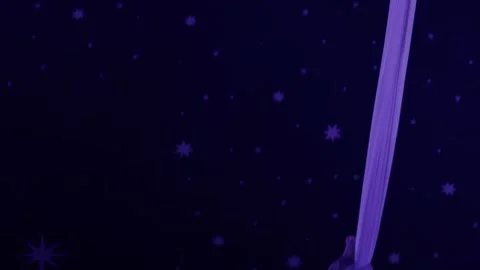 Acrobat performing aerial silks routine with glowing body glitter on dark stage Stock Footage 344865151