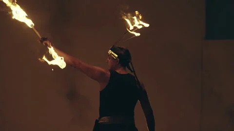 Acrobat performing with fire at night in a mesmerizing show Stock Footage 302039367