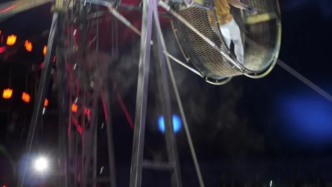 An acrobat in the rotating wheel of death, performing in a circus. Stock Footage 308470997