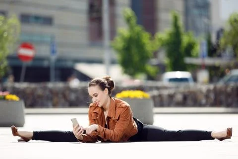 Acrobat using the phone in the city Stock Photos