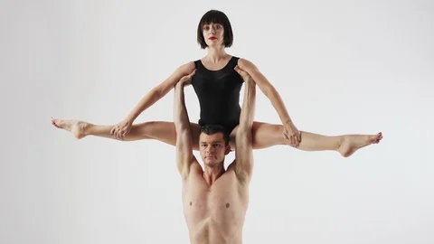 Acrobatic choreographic trick couples on a white background Stock Footage 97917240