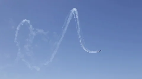Acrobatic figure of a plane during an Air Show by the beach Stock Footage 88390707
