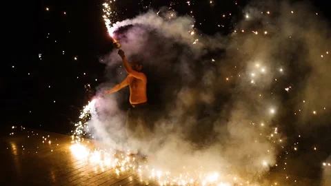 Acrobatic fire performer spinning pyrotechnic torches creating light trails.. Stock Footage 333811277