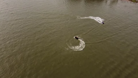 Acrobatic jet ski circling at high speed on Amazon river. Aerial top-down 動画素材 236909734