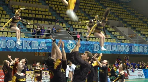 Acrobatic performance of the cheerleading team with crazy jumps. Slow motion. Stock Footage 62732631