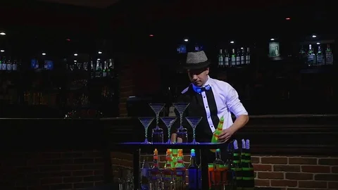 Acrobatic show performed by barman juggling two bottles. bar background. slow Stock Footage