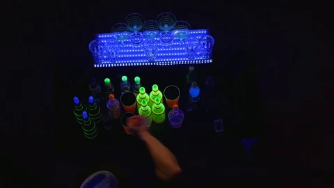 Acrobatic show performed by barman juggling bottles and making cocktail. top Stock Footage